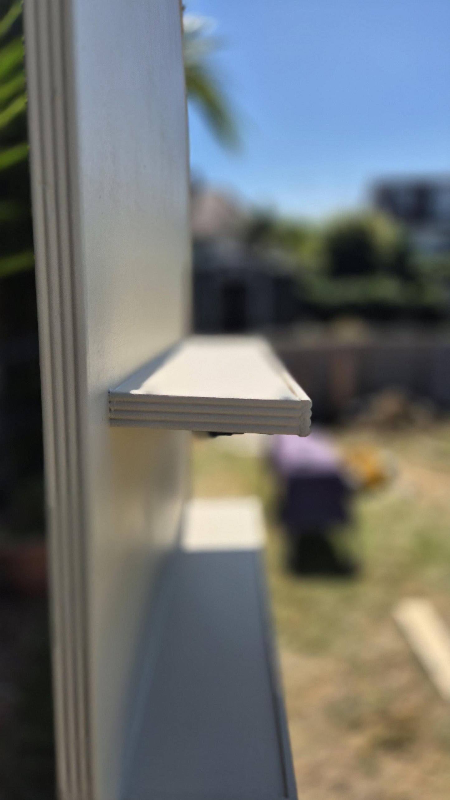 side detailed view of a shelf of a wedding shot wall, showing fine detail of shelf decorative moulding