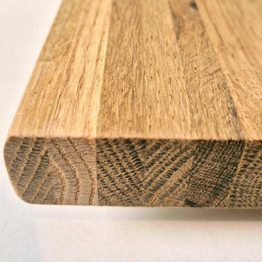 Close-up of a wooden board with a visible grain pattern on a white background